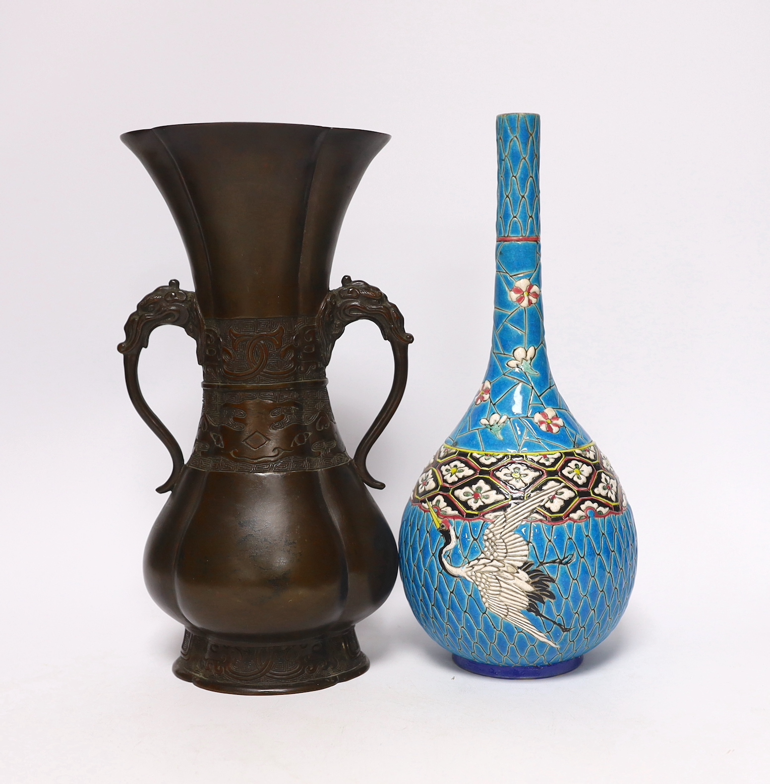 A 19th century Japanese bronze flower vase, with a Japanese enamelled pottery bottle, Meiji, tallest 27 cm (2)